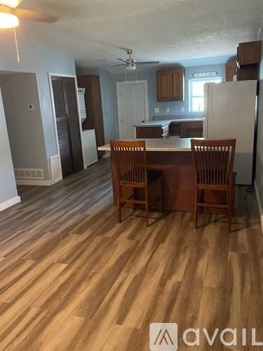 A kitchen with a table and chairs in the middle of the room.