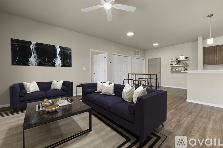 A living room with a dark blue sofa and a coffee table.