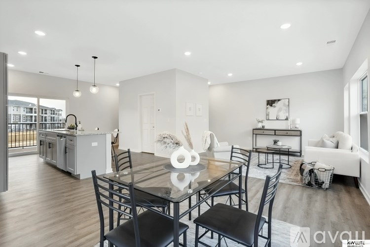 A modern kitchen with a dining table set for four.