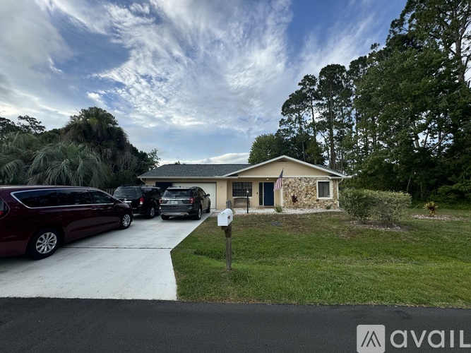A house with a driveway and a mailbox is shown.
