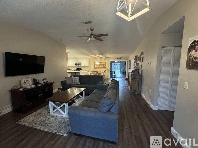 A living room with a grey couch and a wooden coffee table.