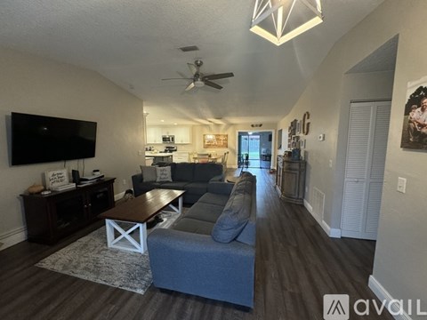 A living room with a grey couch and a wooden coffee table.