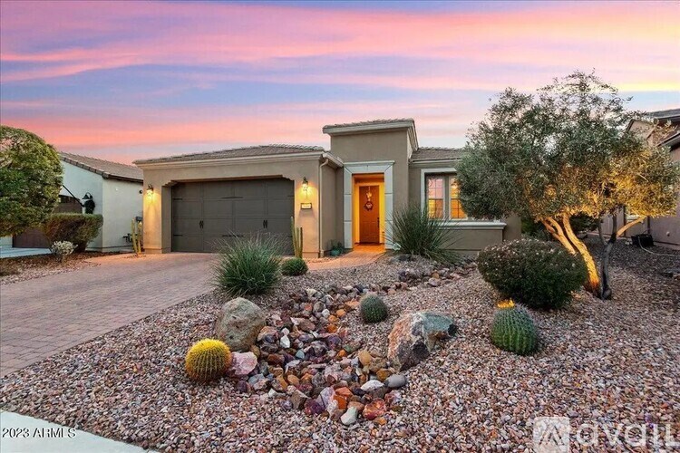 A house with a front yard and a driveway.