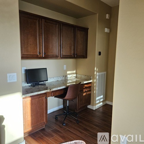 A room with a desk and a computer monitor.