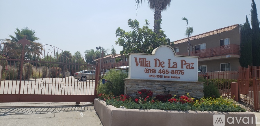A sign for "Villa De La Paz" is in front of a gated entrance.
