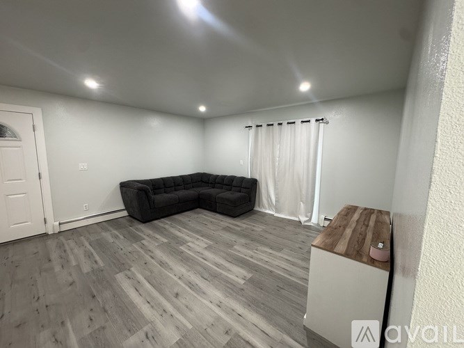 A white bathroom with a toilet, sink, and bathtub.