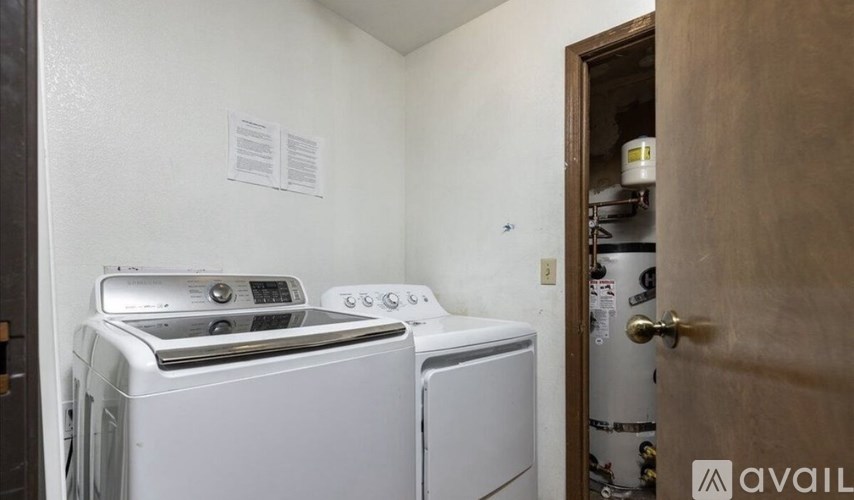 A washer and dryer are in a small room.