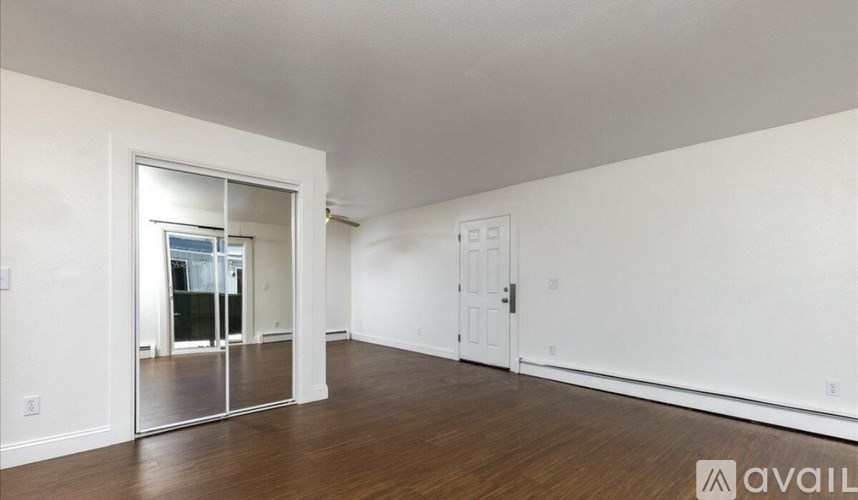 A room with a sliding glass door and a white door.
