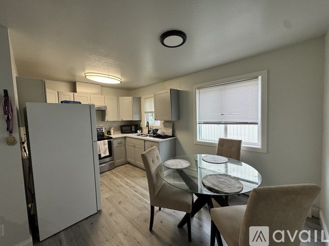 A modern kitchen with a stove, sink, and cabinets.