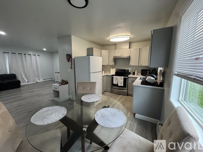 A kitchen with white appliances and cabinets.