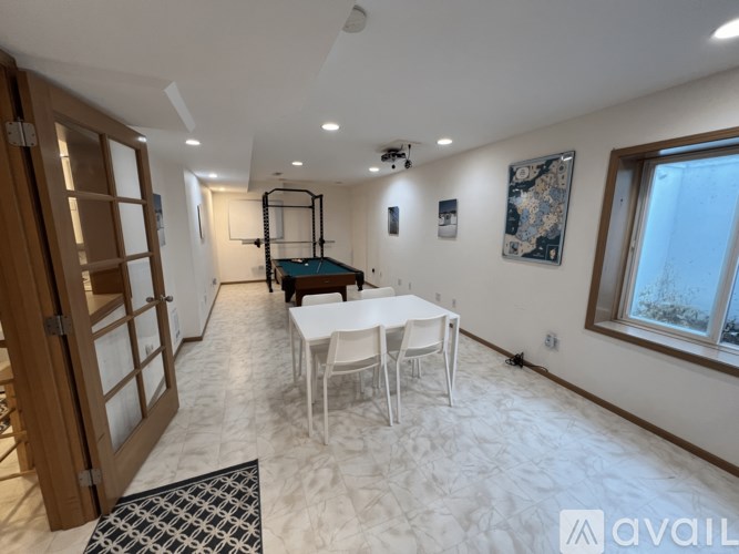 A room with a table and chairs in it.