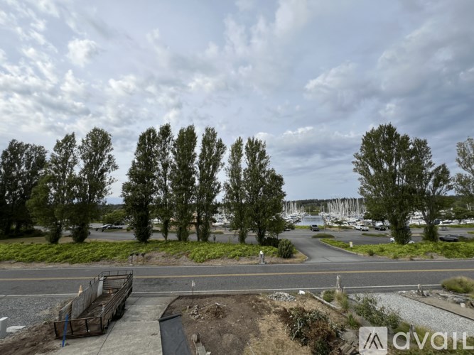 A construction site with a large pile of dirt and a few trees in the background.