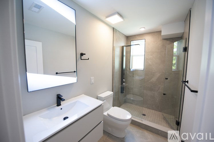 A bathroom with a sink, toilet, and shower.