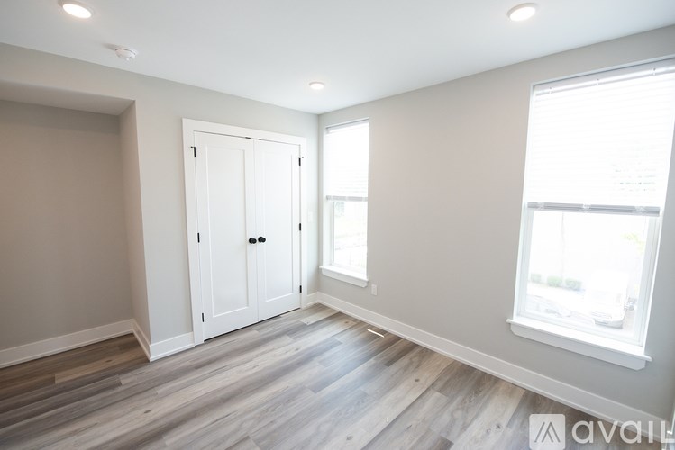 A room with a white door and a window.