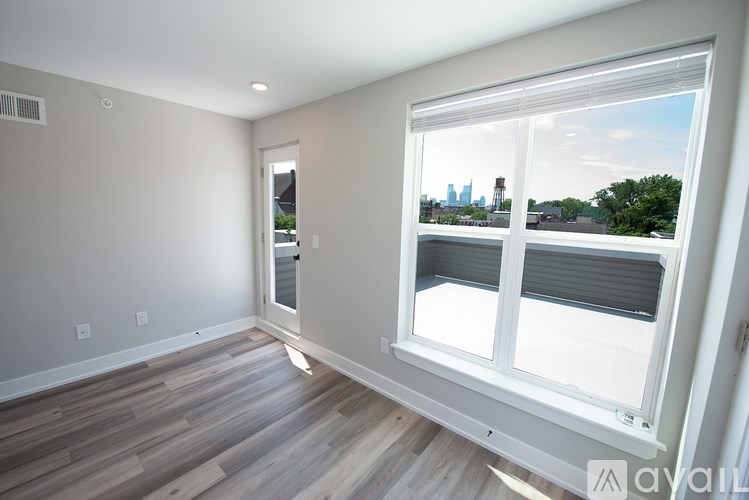 A room with a large window overlooking a city skyline.