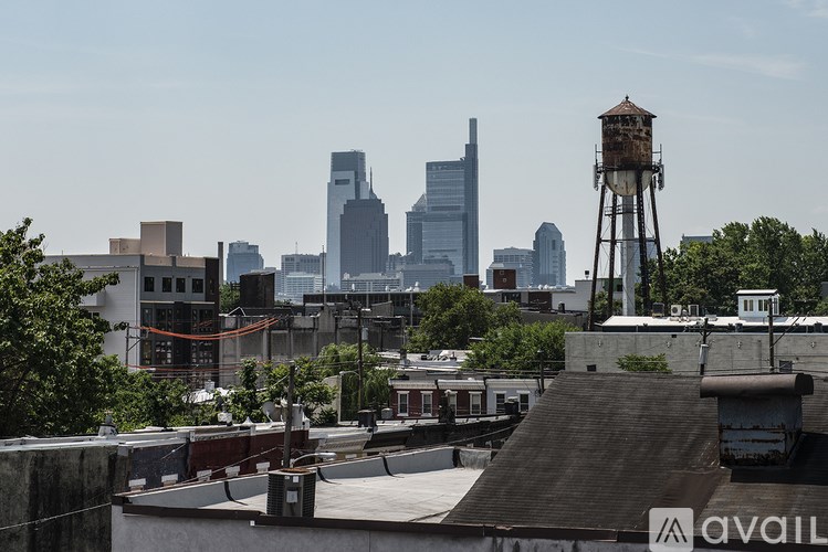 A cityscape with a water tower in the foreground.