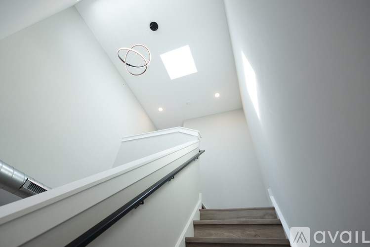 A staircase with a metal handrail and wooden steps.