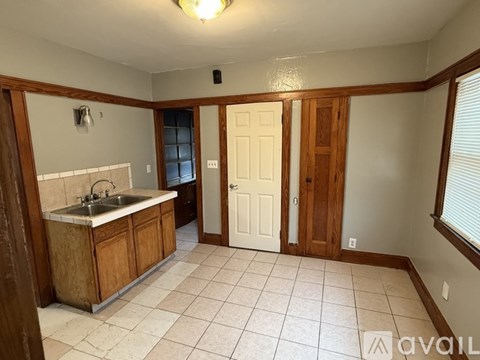 A kitchen with a sink and cabinets.