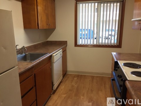 A kitchen with wooden cabinets and a stove top oven.