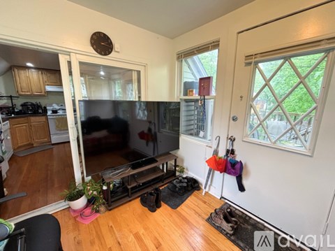 A living room with a black couch and a television.