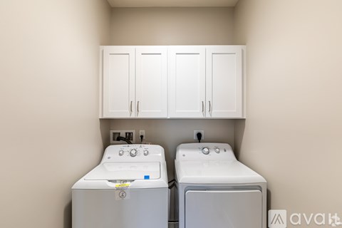 A small laundry room with a washer and dryer.