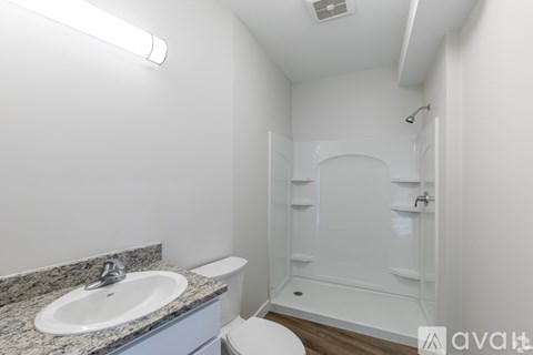 A bathroom with a sink, toilet, and shower.