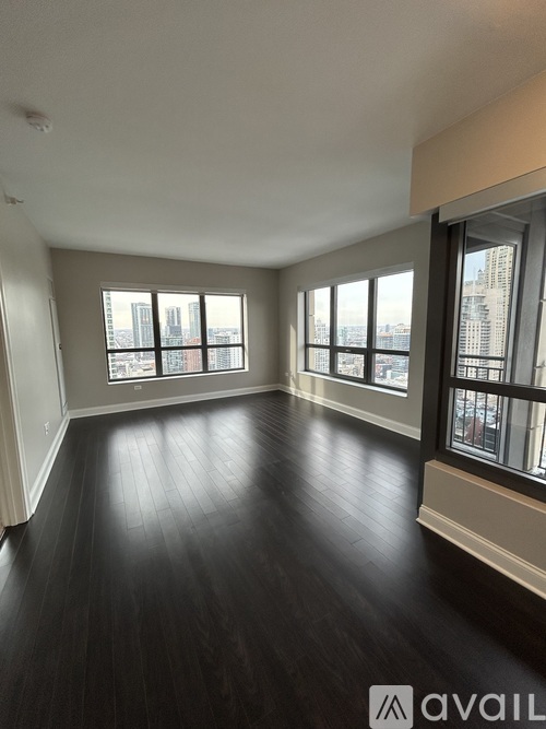 A room with wooden floors and large windows.