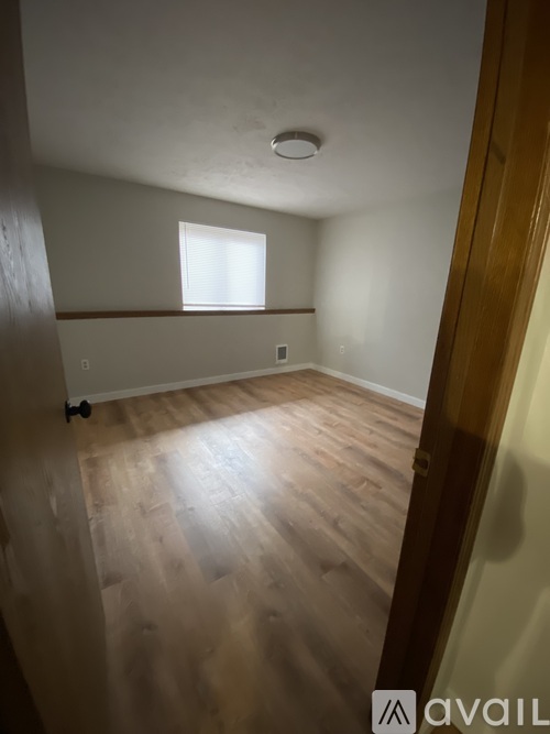 A room with wooden floors and a window.