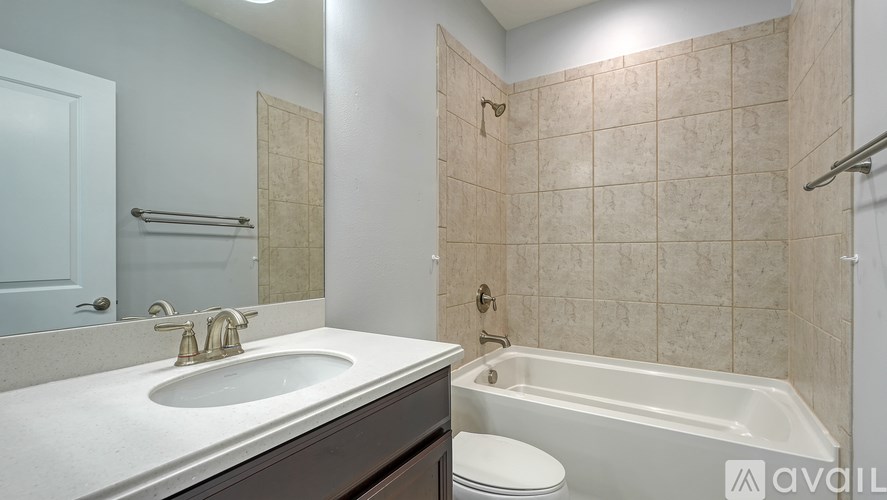 A bathroom with a white sink and a white toilet.