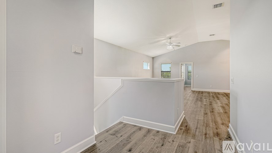 A room with a white wall and a wooden floor.