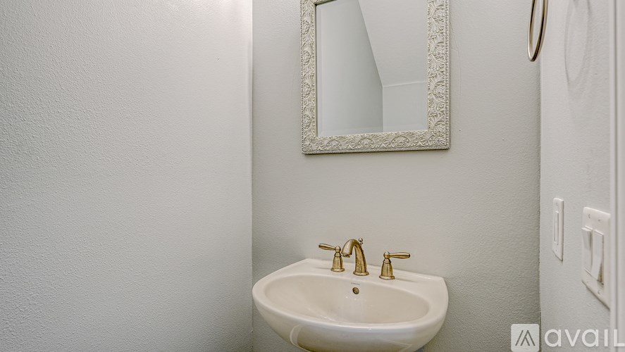 A bathroom with a sink and mirror.