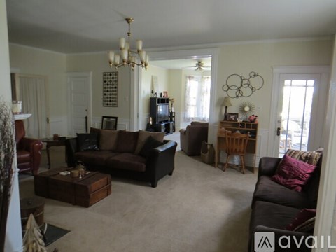 A living room with a dark brown couch and a wooden coffee table.