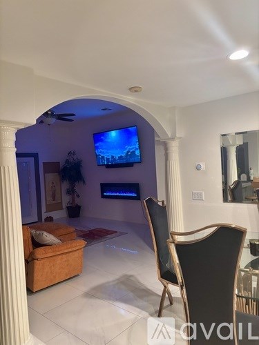 A living room with a television and a chair.