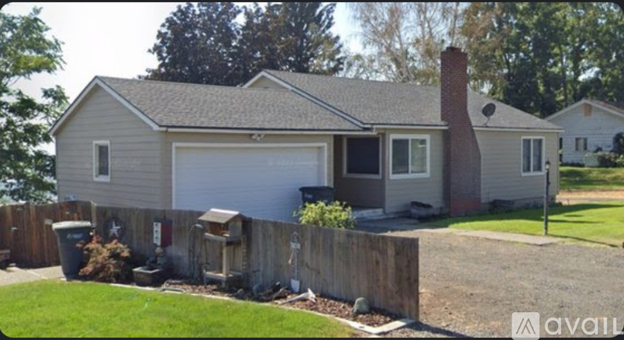 A house with a grey roof and a chimney is available for rent.