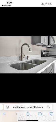 A modern kitchen sink with a chrome faucet.