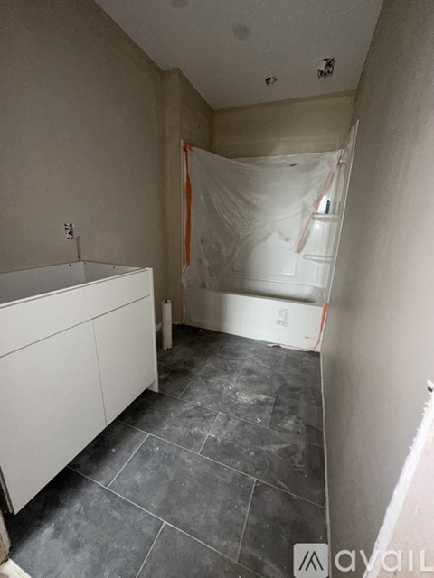 A room with a white cabinet and a tiled floor.