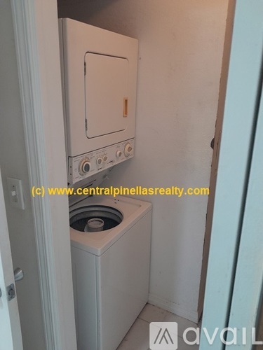 A small white kitchen with a dishwasher and a stove top oven.