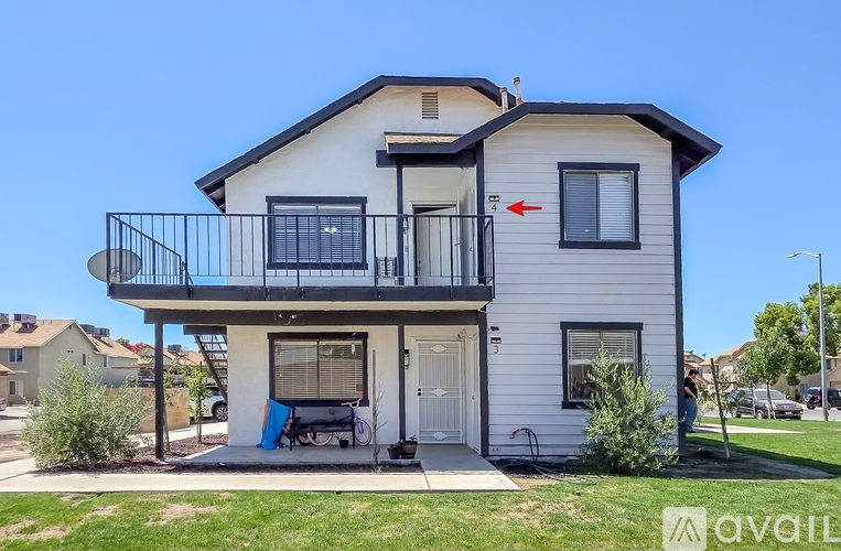 A two-story house with a balcony on the second floor.