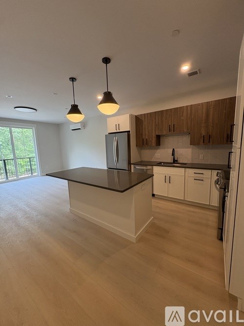 A kitchen with a black countertop and wooden cabinets.