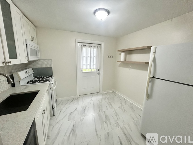 A room with wooden floors and a patterned wallpaper.