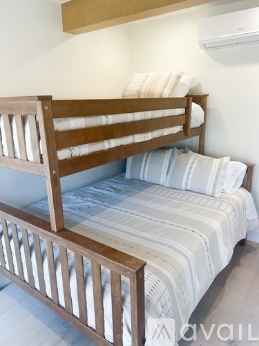 A bed with white bedding and a wooden headboard.
