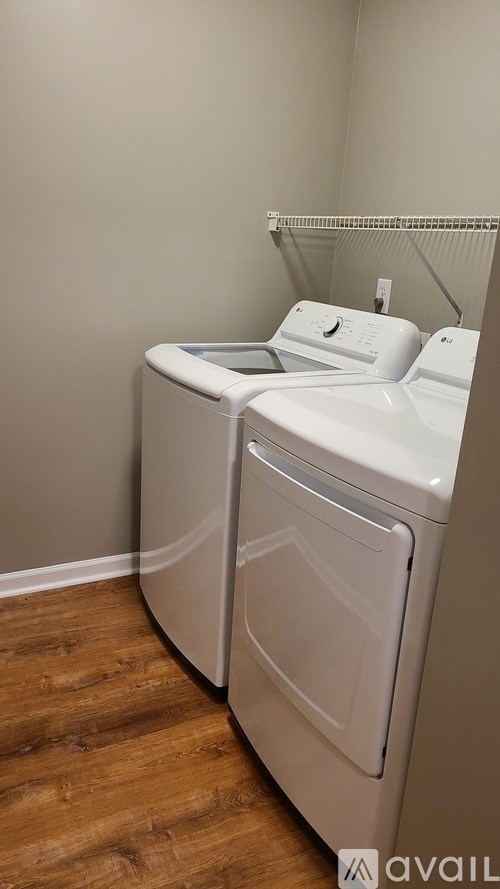 A white dryer and washer in a laundry room.