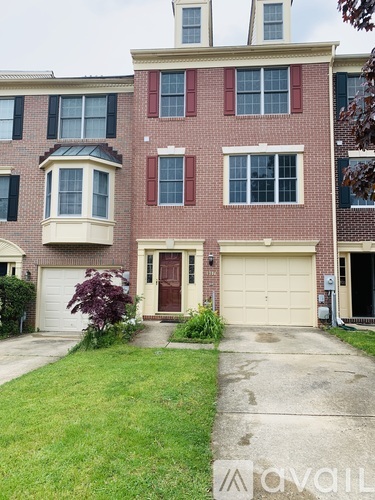 A red brick house with a white garage door.