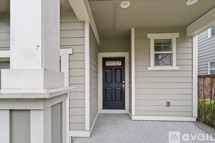 A house with a black door and a window on the side.
