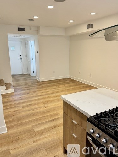 A kitchen with a white counter top and a stove with a white oven.
