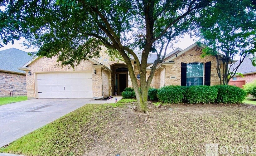 A house with a tree in front of it.