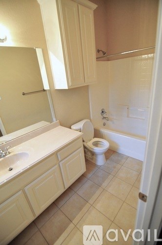 A bathroom with a toilet, sink, and bathtub.
