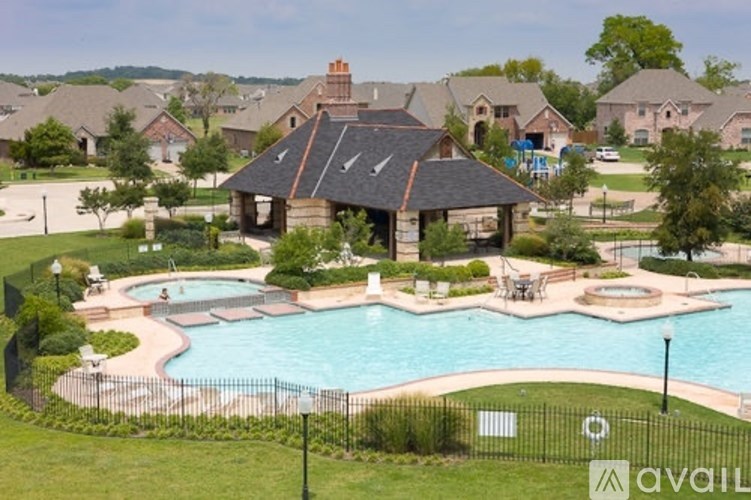 A large house with a pool in front of it.