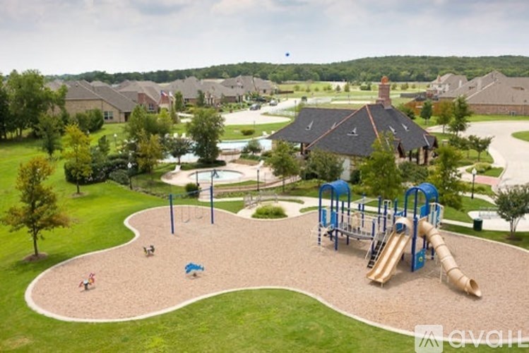 A playground with a slide, swings, and a sandbox.