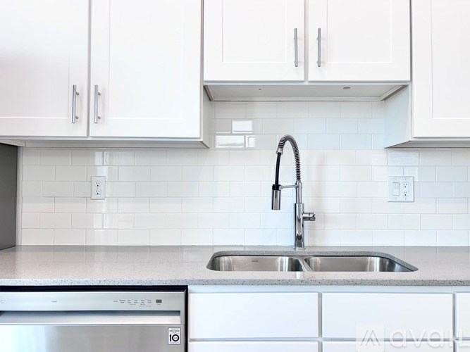 A kitchen with a sink and a dishwasher.